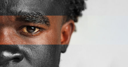 Close-up of a mans face showing expression and emotion with focus on his intense eye and detailed facial featuresの写真素材