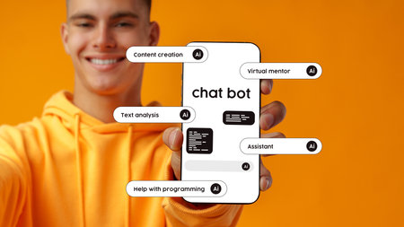 Young man showcasing a chatbot interface on a smartphone against a bright orange backgroundの写真素材