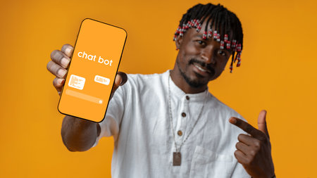 Man showcasing chatbot application on mobile device against vibrant orange backdropの写真素材