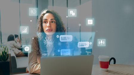 Technology and creativity blend as a woman works on a laptop in a modern workspace during the day