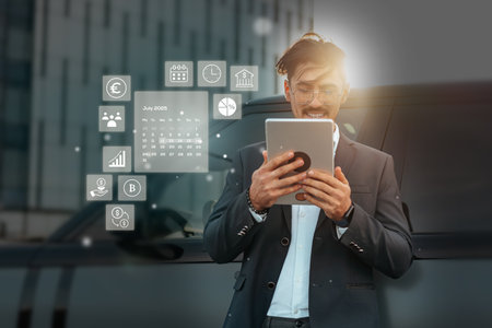 Business professional using a tablet for financial planning in an urban setting during the dayの写真素材
