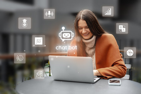 Woman smiling while interacting with a chat bot on her laptop in a cozy outdoor setting during a...