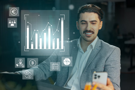 Business professional engaged in digital finance analysis in a modern office setting during daytimeの写真素材