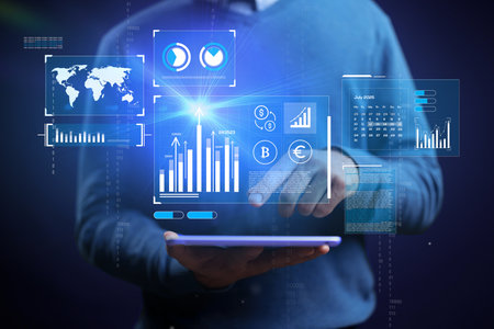 Business professional analyzing data trends on tablet with digital graphs and charts in modern...