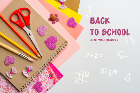 Back to school preparations with colorful books and digital devices in a creative design