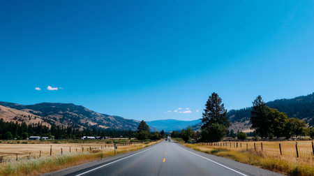 Scenic highway through mountainous landscape on a clear, sunny day in summerの素材