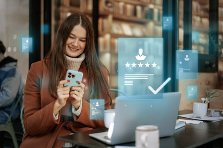 Young woman using smartphone while reviewing services in a cozy cafe with digital rating overlaysの写真素材