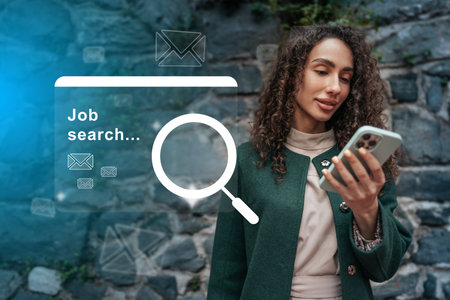 Woman engaging in job search using smartphone in an outdoor urban setting during the dayの写真素材