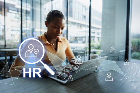 Professional woman working on human resources tasks in a modern office space during daylightの写真素材