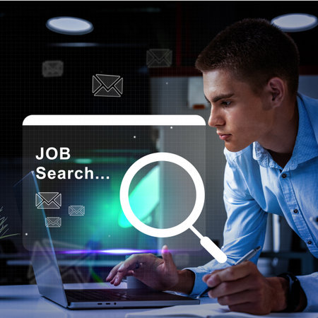 Young professional engaging in job search on laptop while focusing intently in a modern workspace during evening hoursの写真素材