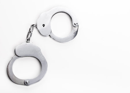 Silver handcuffs close up isolated on white background