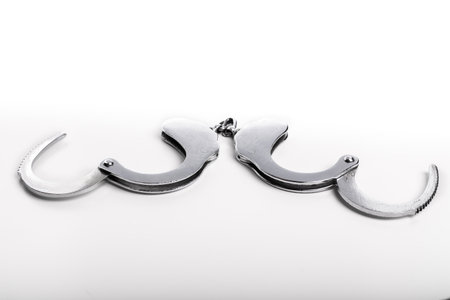 Silver handcuffs close up isolated on white background