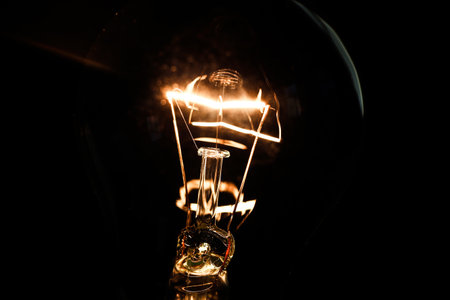 Close-up of electrical bulb on black background