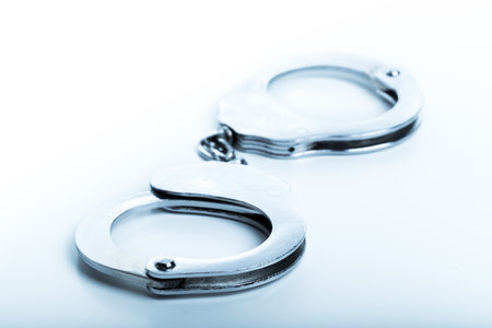 Silver handcuffs close up isolated on white background