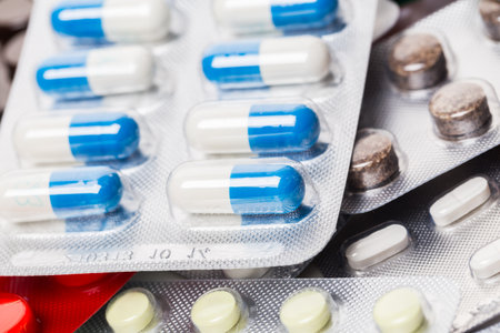 A pile of pills in blister packs close up
