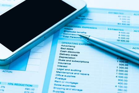 Business and finance concept with financial chart, smartphone and pen