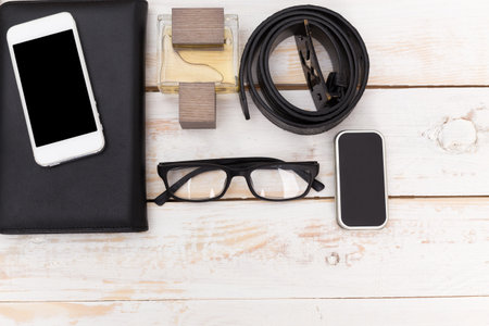 Top view of businessmans accessories set on wooden background