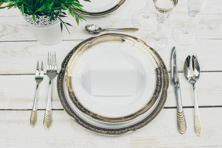 table setting with plates and tableware on white background top view