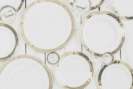 top view of table setting with plates and tableware on white background