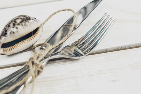 Set of silverware on white wooden table close up