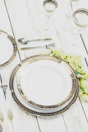 top view of table setting with plates and tableware on white background