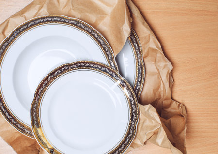 Set of white table ware with golden border