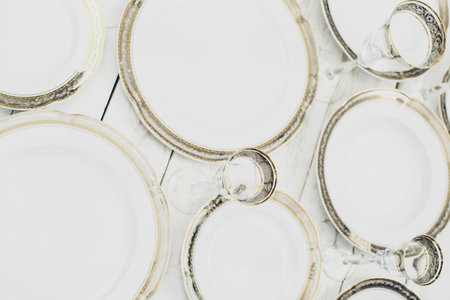 top view of table setting with plates and tableware on white background
