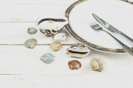 Elegant tableware on white wooden background close up