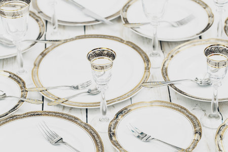 top view of table setting with plates and tableware on white background
