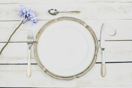 table setting with plates and tableware on white background top view