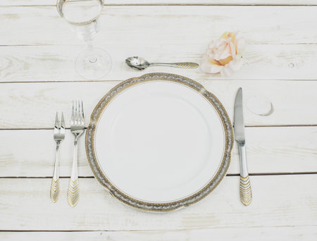 table setting with plates and tableware on white background top view