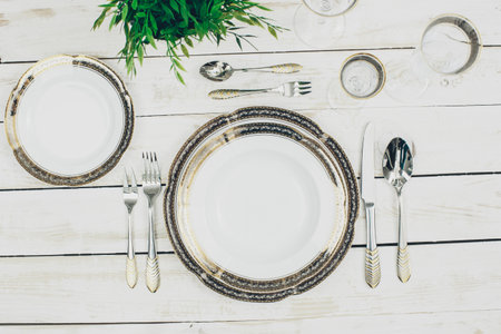 table setting with plates and tableware on white background top view