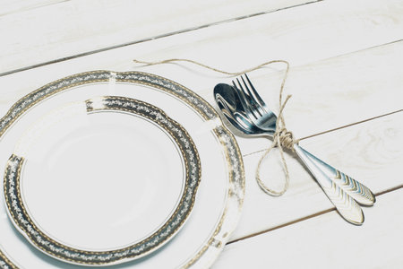 Set of white tableware with golden border