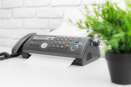 Fax machine, office equipment on white table
