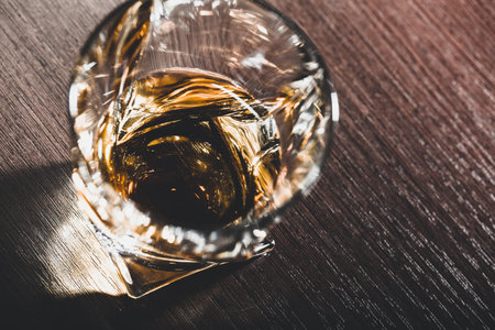 Whiskey glass in the dark close up