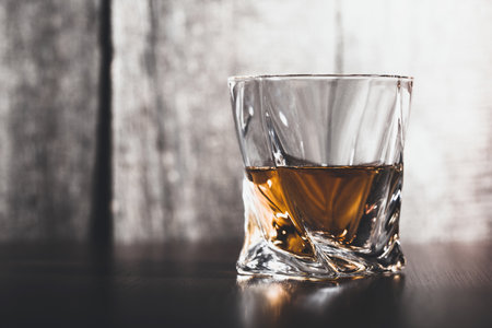 Whiskey glass in the dark close up
