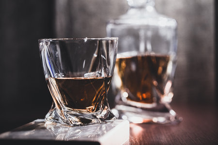 Whiskey glass in the dark close up