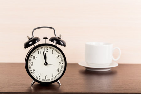 Black alarm clock on the table.