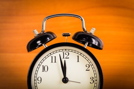 Close up of a black old-fashioned alarm clock