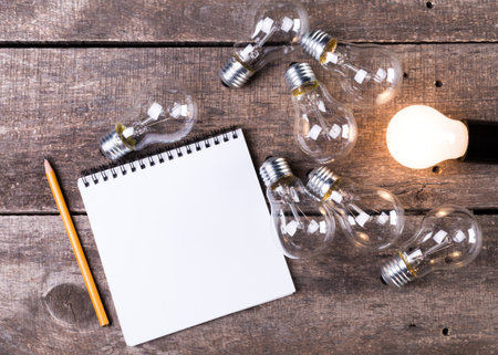 Lightbulb and blank open notepad. Having an idea concept