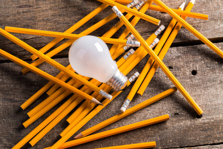 Composition of Light bulb with pencils. Creativeness concept