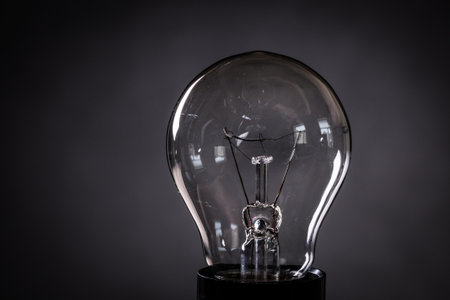 Close-up of electrical bulb on black background