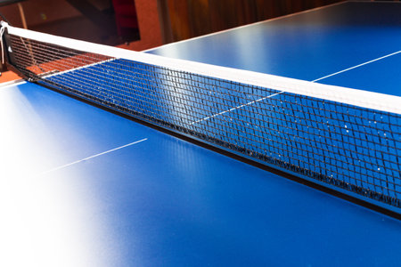 Net on blue ping pong table close upの写真素材