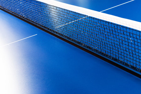 Net on blue ping pong table close up