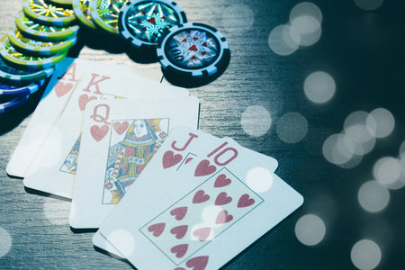 Poker cards and chips on blurred background