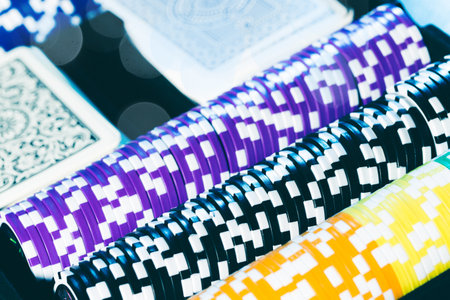 Poker cards and chips on blurred background