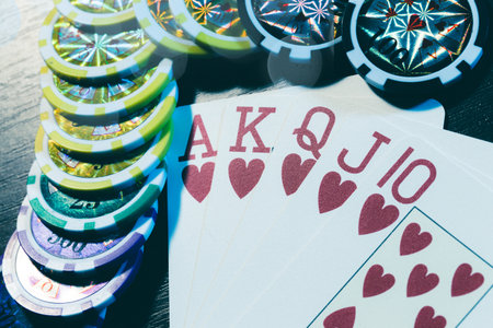 Poker cards and chips on blurred background