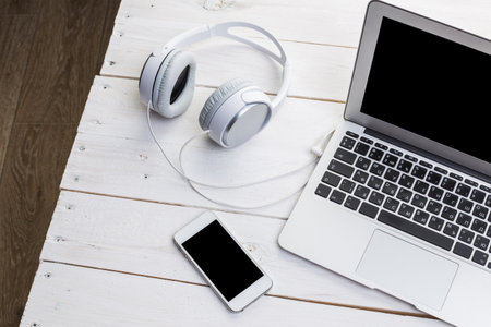 White wooden table with gadgets, view from above
