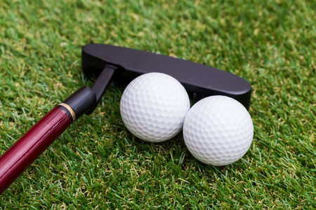 Indoor mini golf equipment set on green grass background