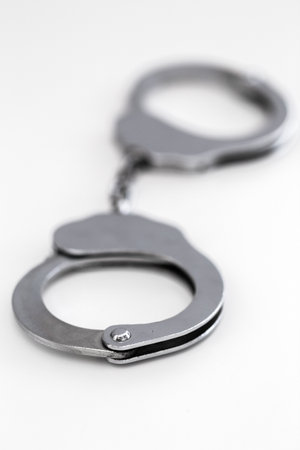 Silver handcuffs close up isolated on white background
